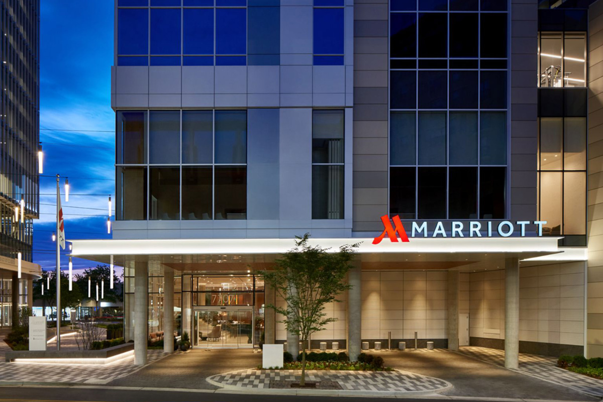 Exterior of a glass-walled hotel in the late evening