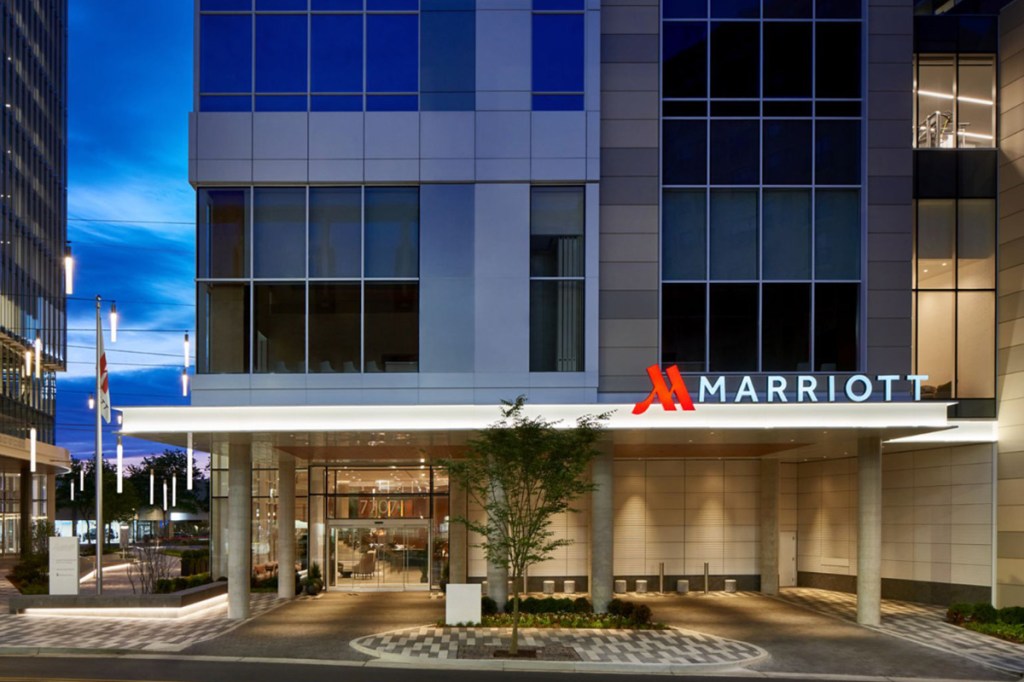 Exterior of a glass-walled hotel in the late evening