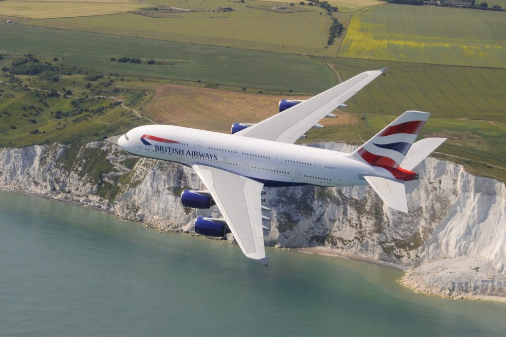 A British Airways A380 flying over the Cliffs of Dover in the UK.