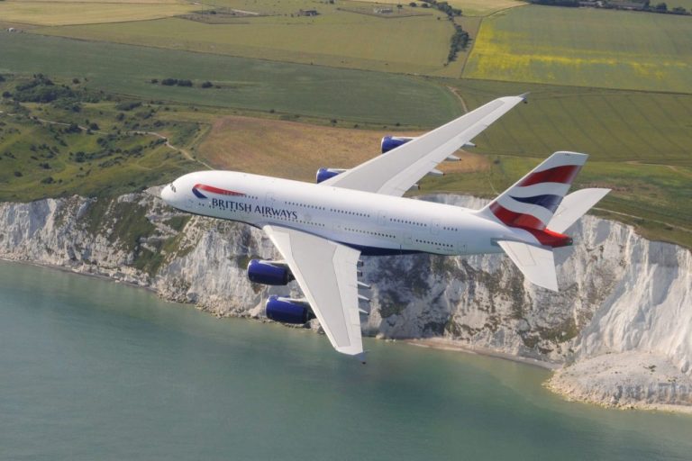 A British Airways A380 flying over the Cliffs of Dover in the UK.