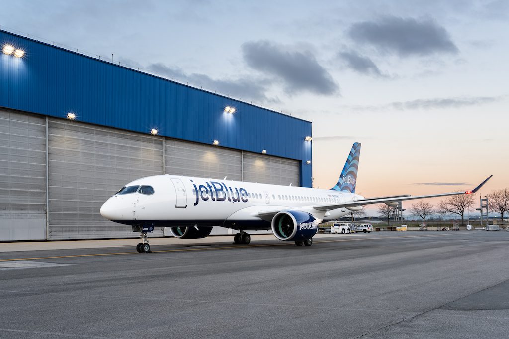 The passenger plane outside a hanger at dusk