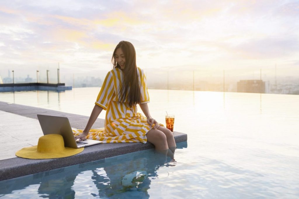 A woman enjoying. blended work and leisure travel trip.
