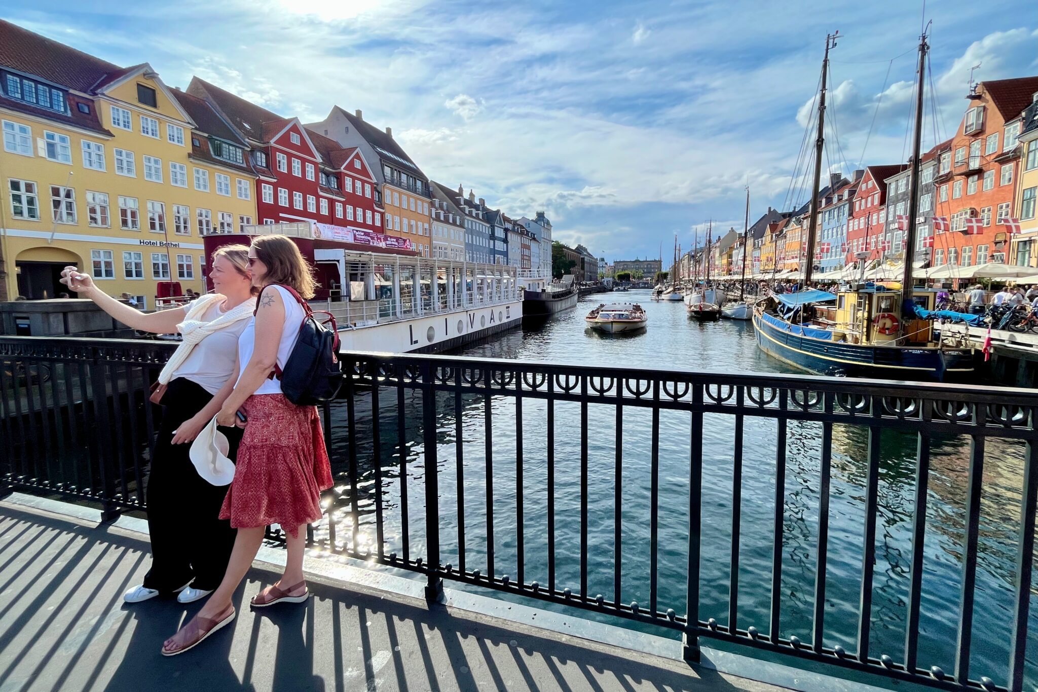 A couple posing for a photograph along a canal in Copenhagen