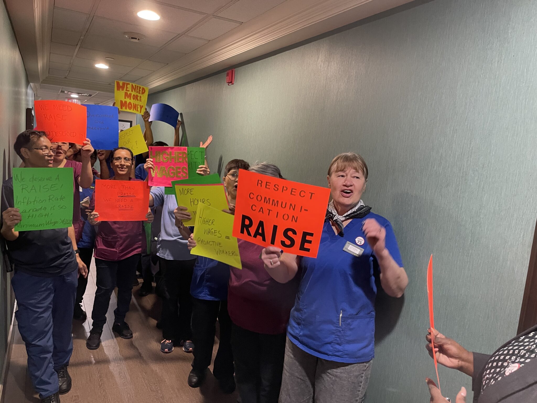 Hotel workers gather for morning action in hallway