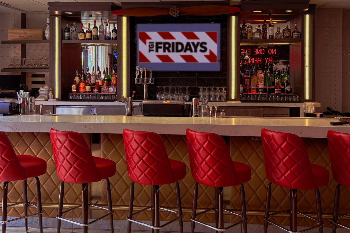 inside a TGI Fridays fast casual restaurant looking at the counter where there are stools for guests at a new restaurant inside a hotel in california