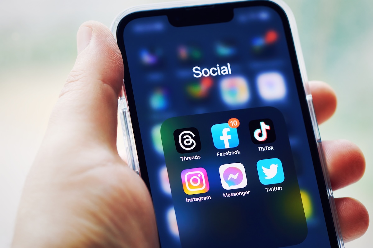A smartphone with a screen full of social media app icons.