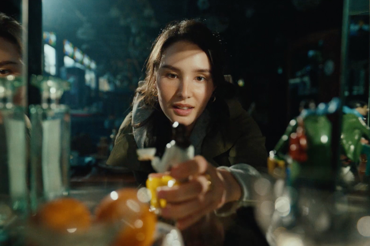 a still of a woman in an ad campaign she is looking at fancy food