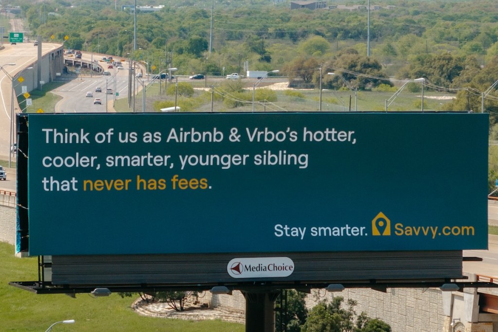 A billboard with a highway in the background in Austin, Texas.