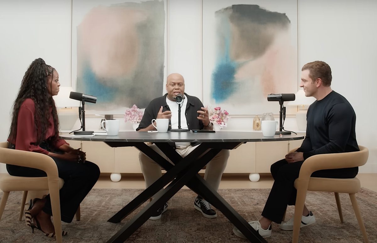 3 people sitting around a table during a podcast.