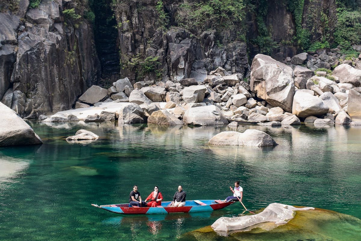 Tourists riding a boat in Dawki, Meghalaya.