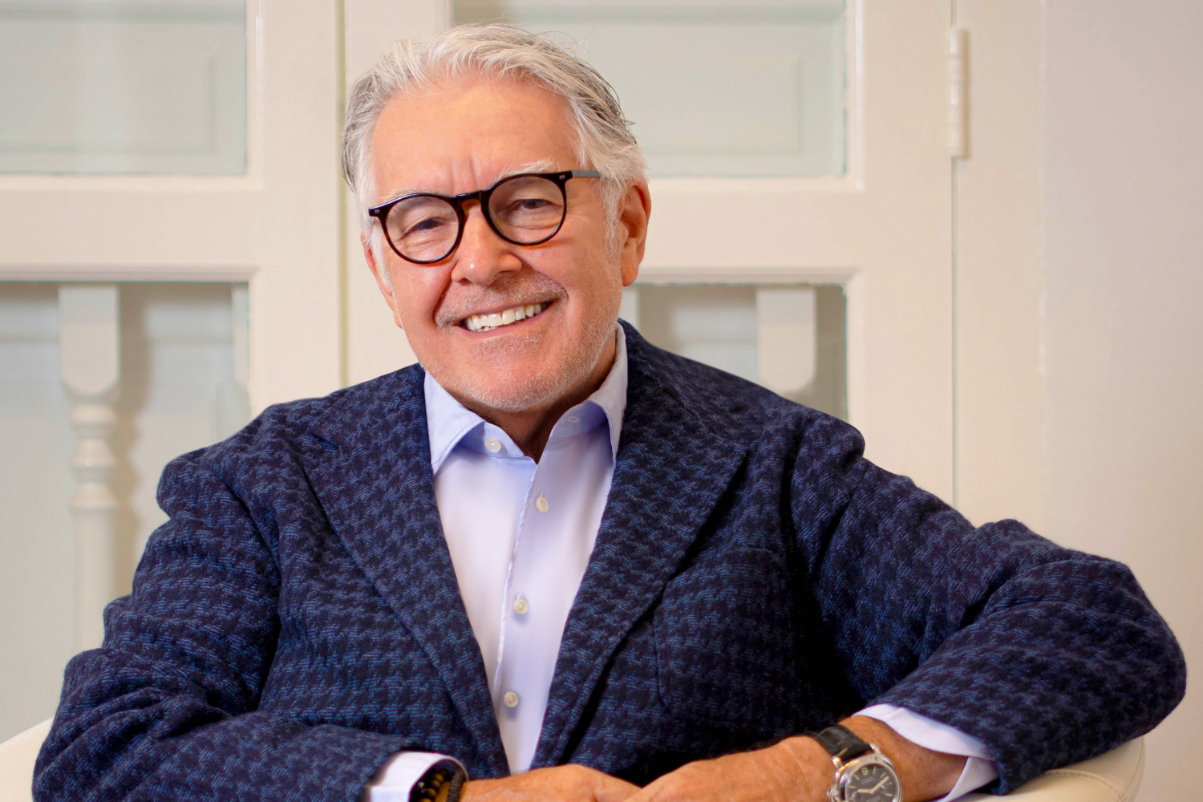 a smiling luxury hotel executive, Neil Jacobs