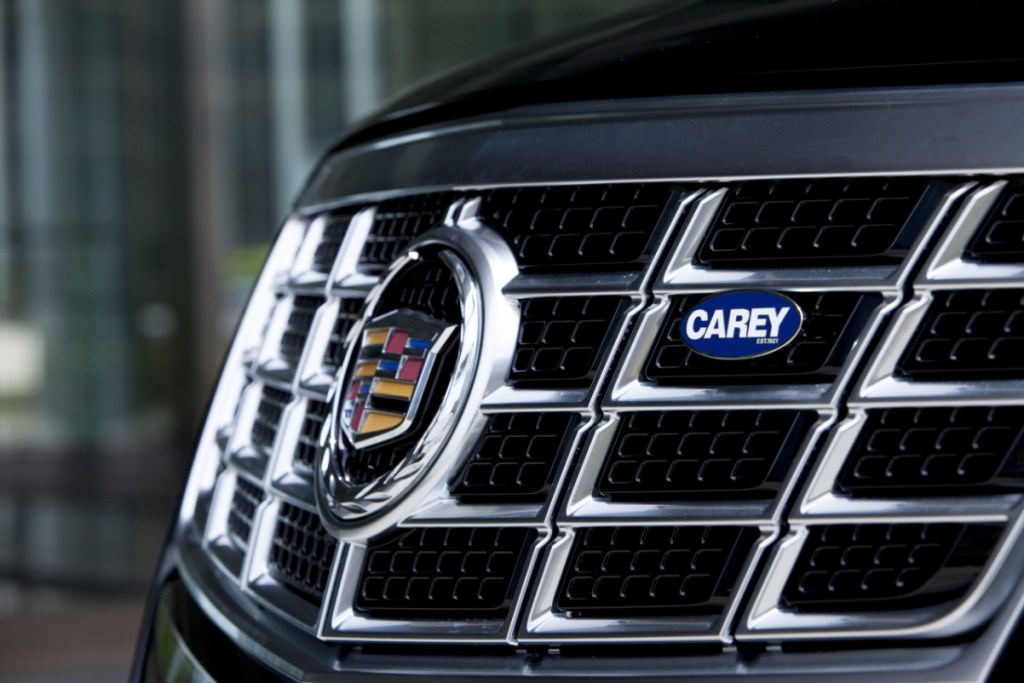 image of the grill of a limousine with the logo of chauffeur service Carey on it