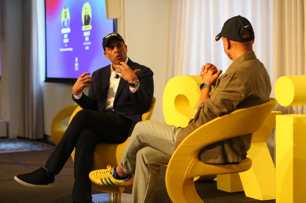 a hotel industry leader talks on stage at a skift event