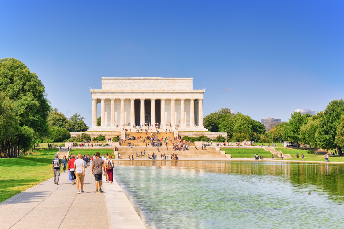 A reflecting pool with a monument behind it