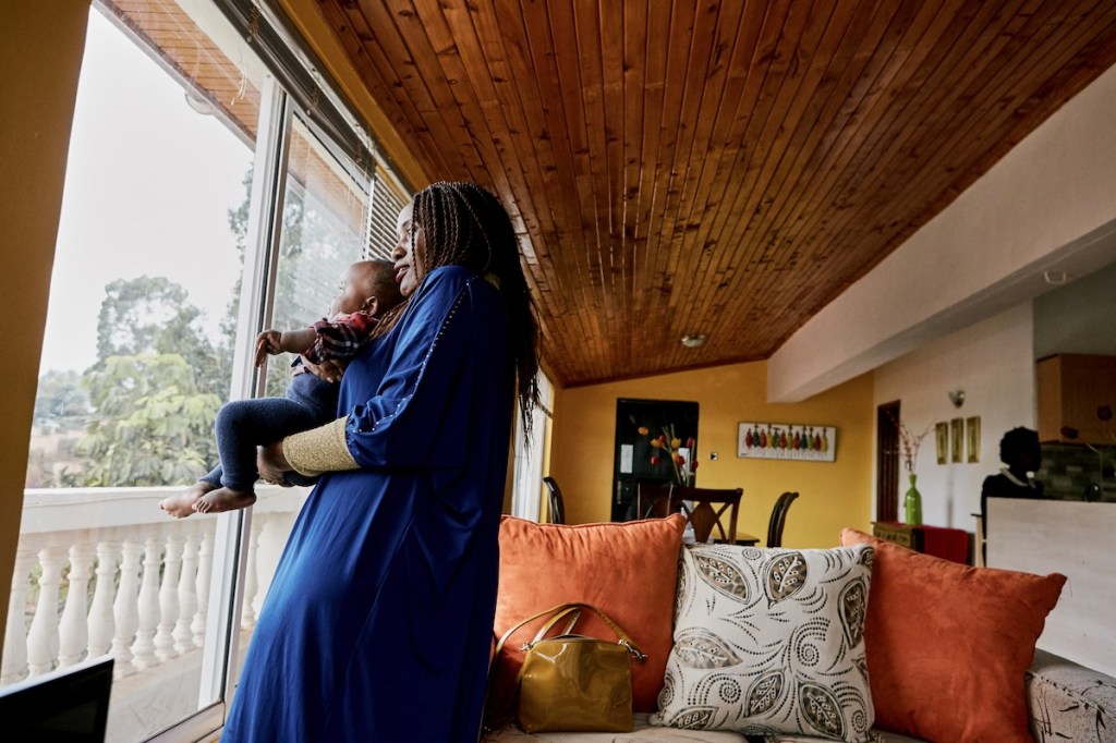 A woman holding a child in an Airbnb in Nairobi.