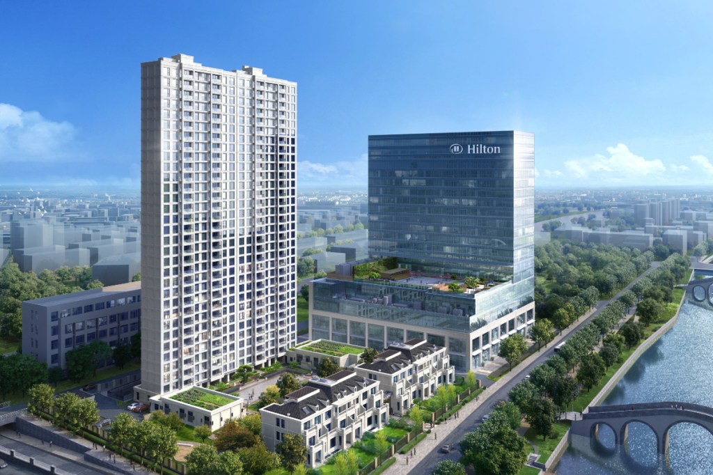 Hilton Yuyao hotel shown next to a river