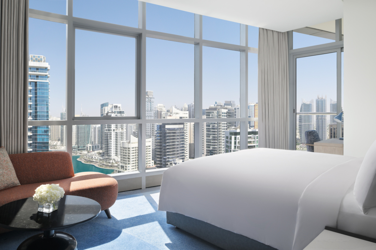 image of a bedroom in a hotel overlooking the city of Dubai