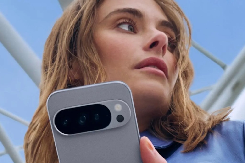 A woman holding a Google Pixel phone.