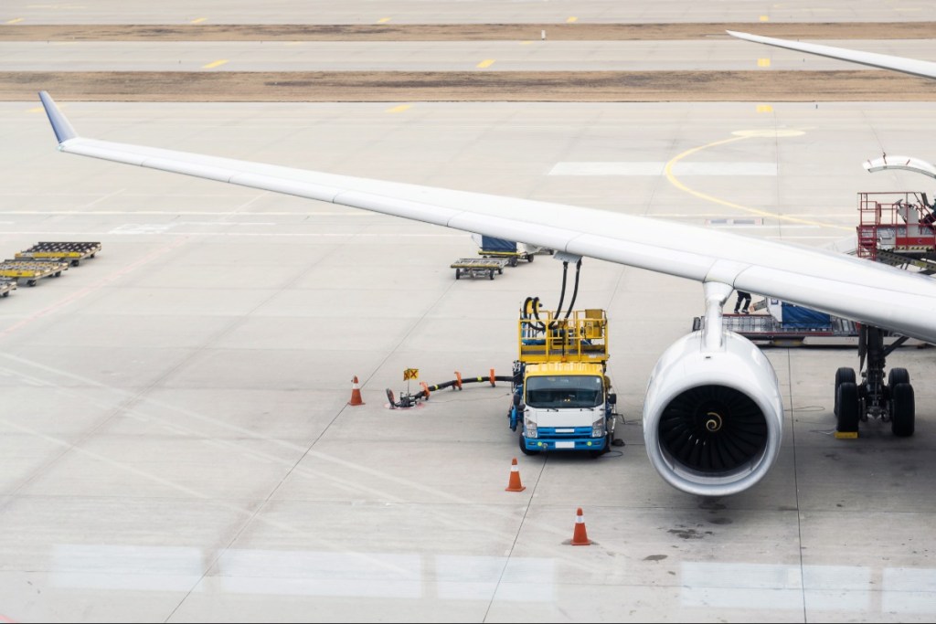 A plane refueling on an airport tarmac.