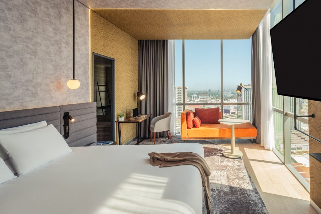 The view from the inside of a guest room at a Novotel hotel in Mexico City—it's bright and sunny with big windows.