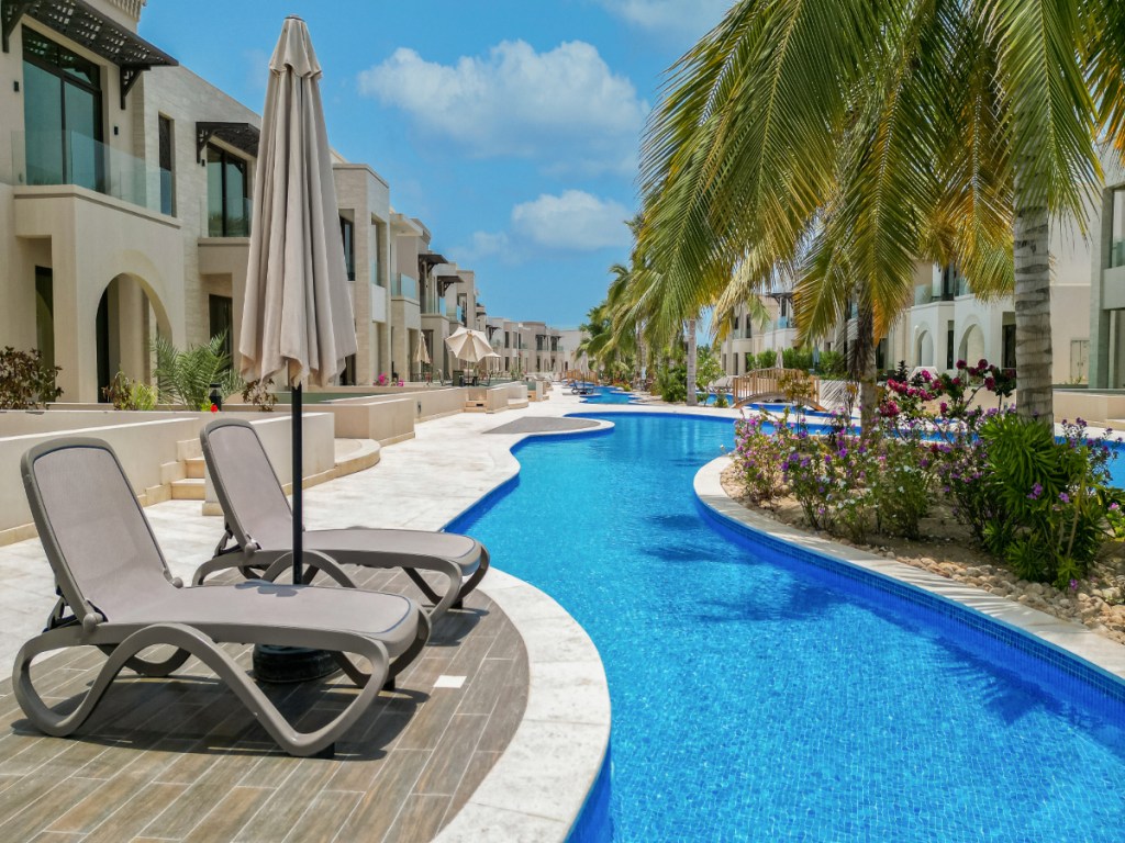 A vacation rental with a swimming pool that winds like a river.