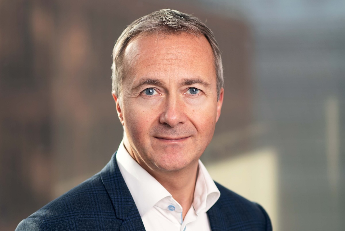 Headshot of an executive wearing a sports coat.