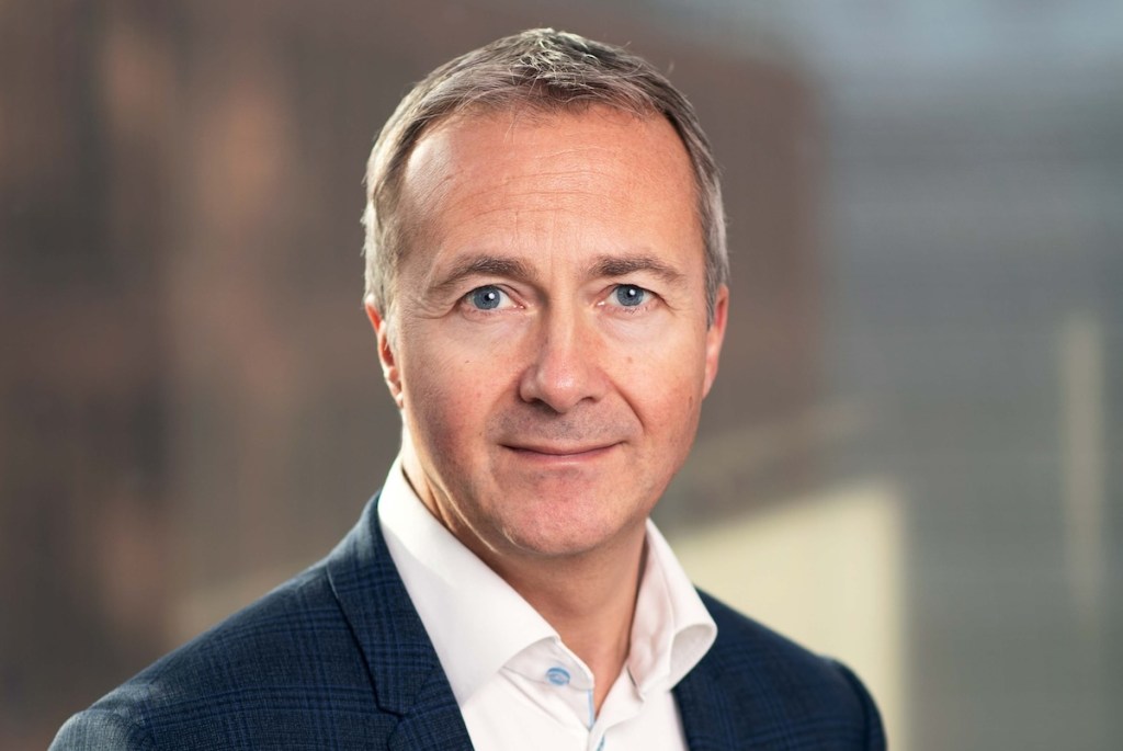 Headshot of an executive wearing a sports coat.