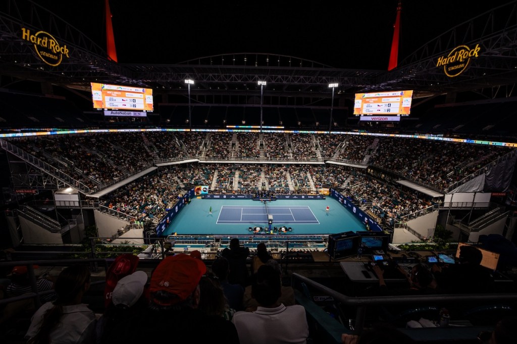 A wide shot of a crowd at the Hard Rock Stadium in Miami Gardens, Florida, watching the Miami Open tennis tournament.