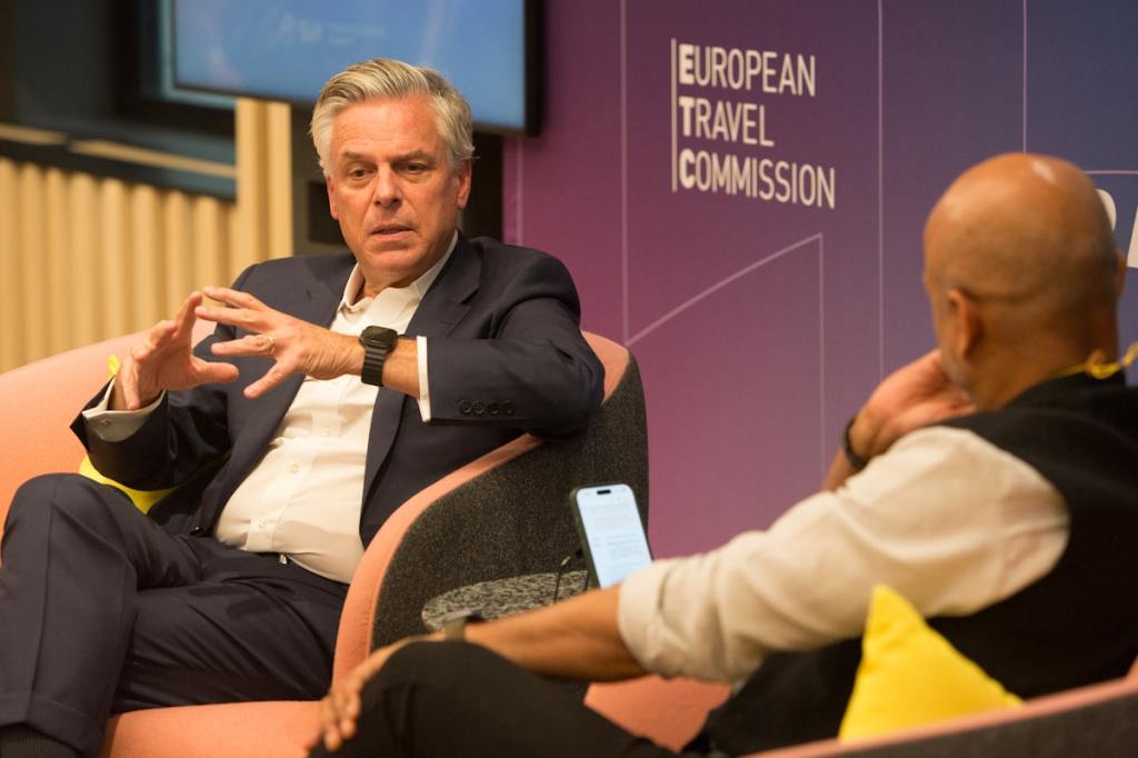 two men converse on stage.