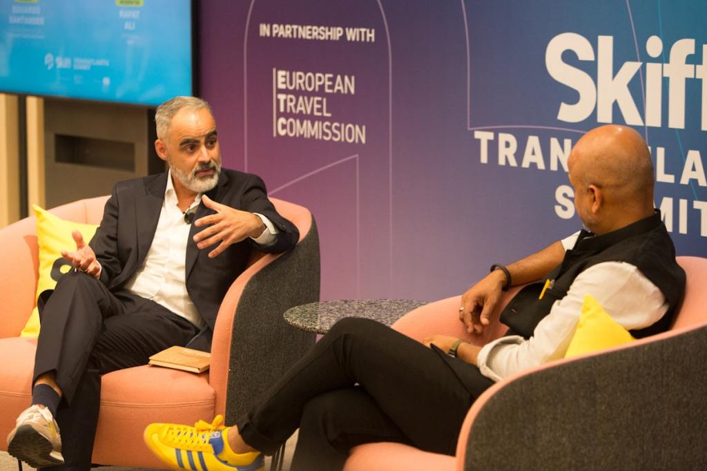 two men converse on stage.
