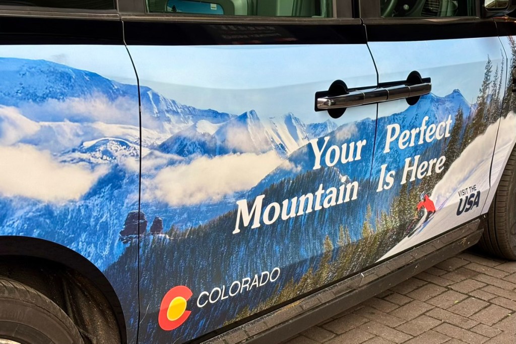 an advertisement on the side of a London black cab