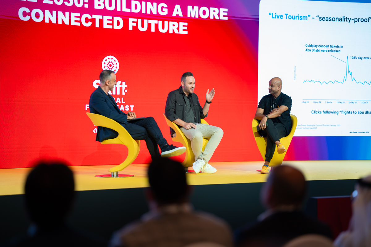Three men in conversation on stage
