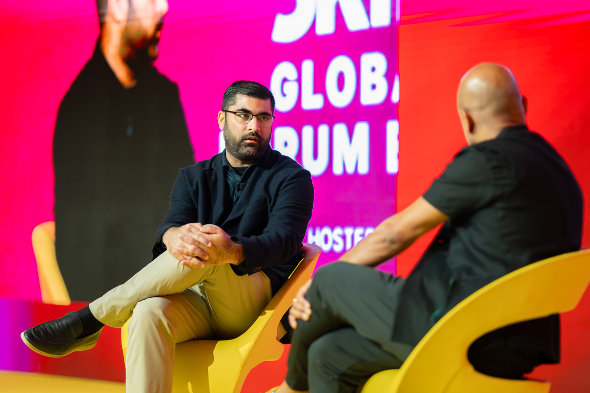 two men speaking on stage