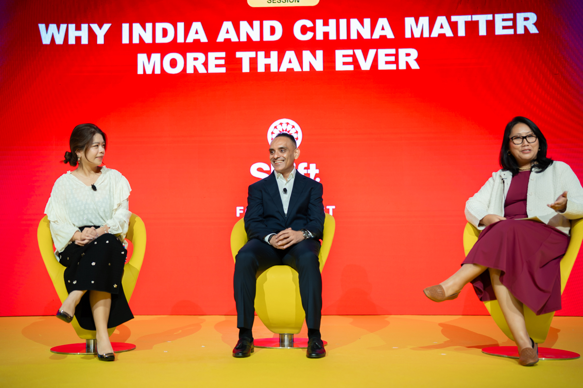 Three people in conversation on stage