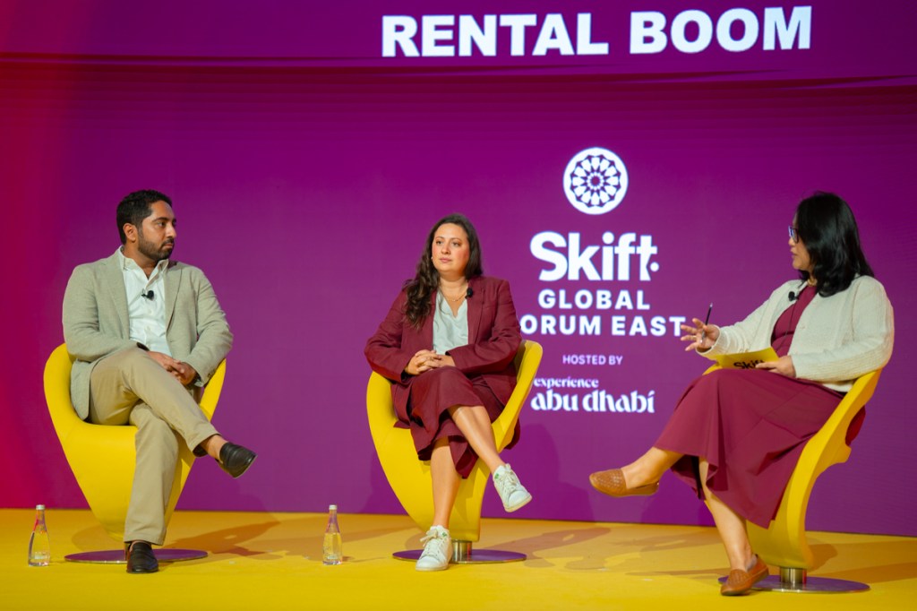 Three people in conversation on stage