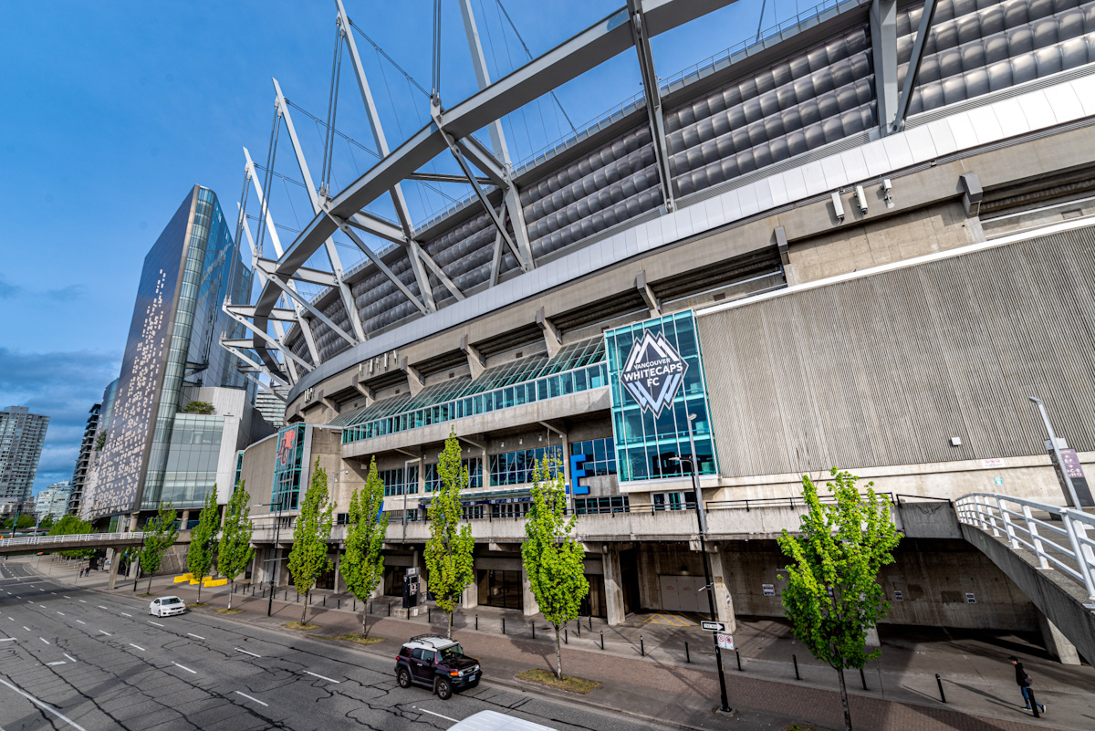 A city street running along side a large stadium