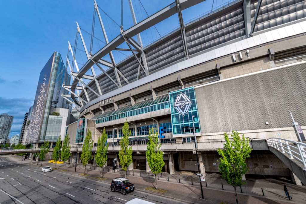 A city street running along side a large stadium
