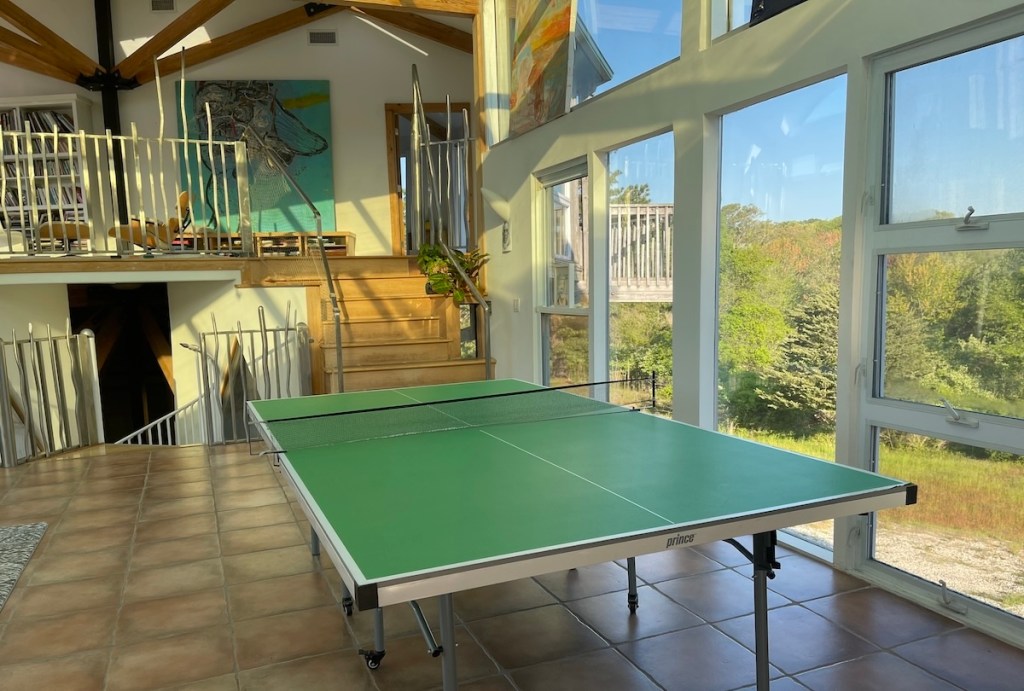 A vacation rental with a ping pong table in the foreground.