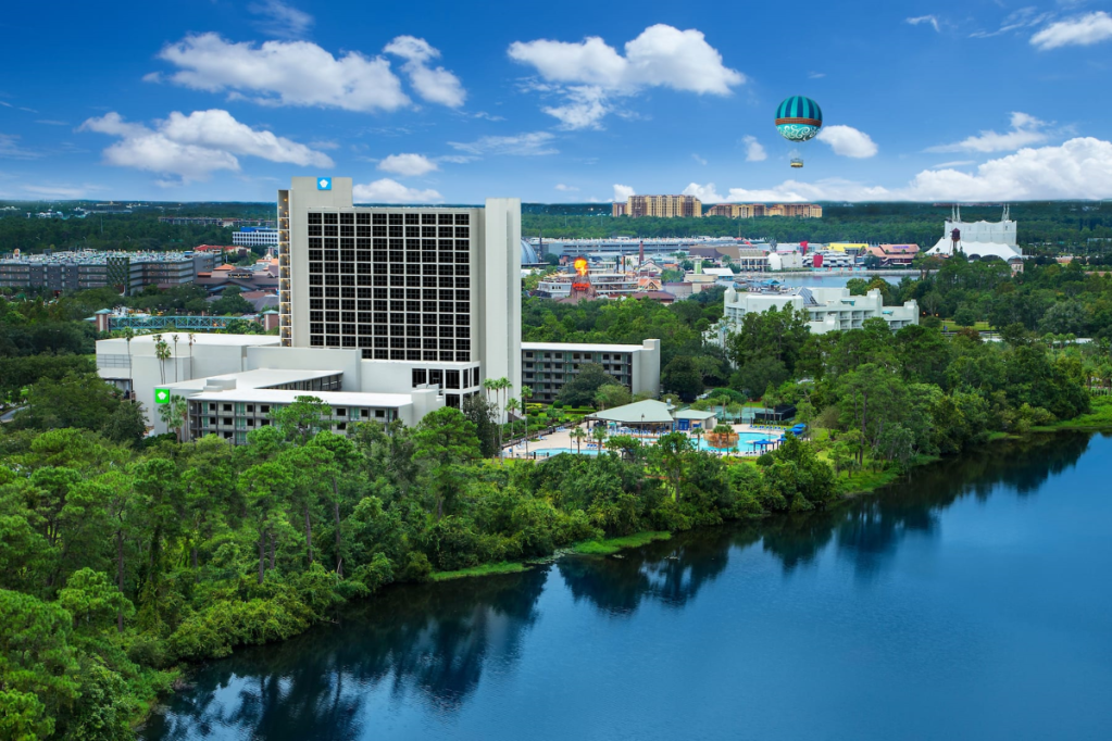 view of a Wyndham hotel along the water on a sunny day