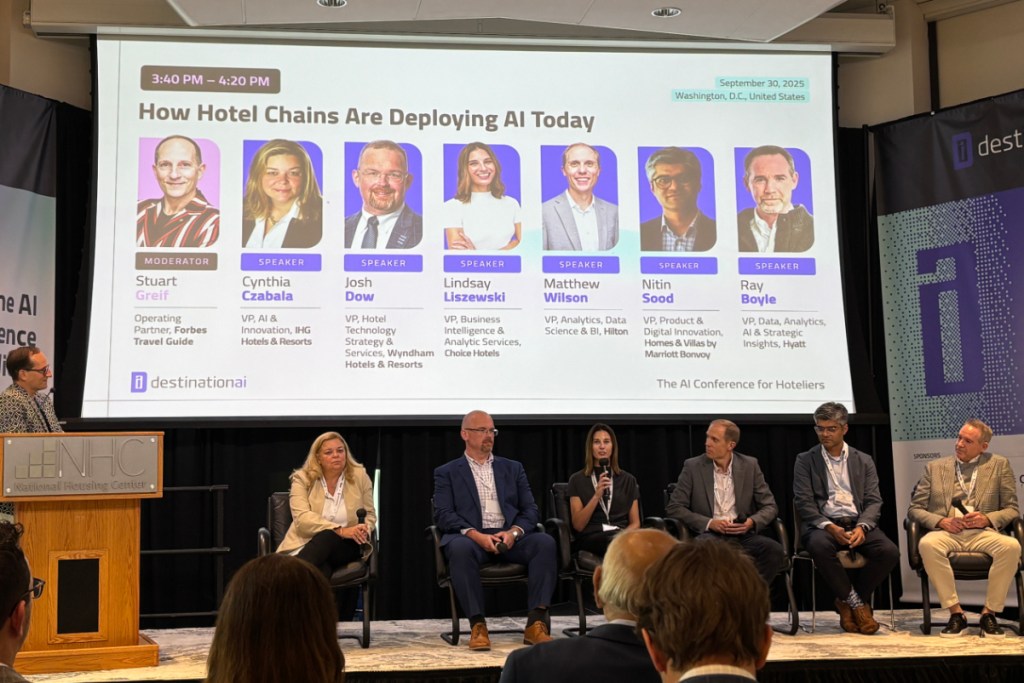 hotel executives talking on a stage