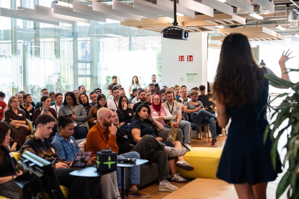 Employees in an office sitting on chairs in the audience and listening to a lecturer.