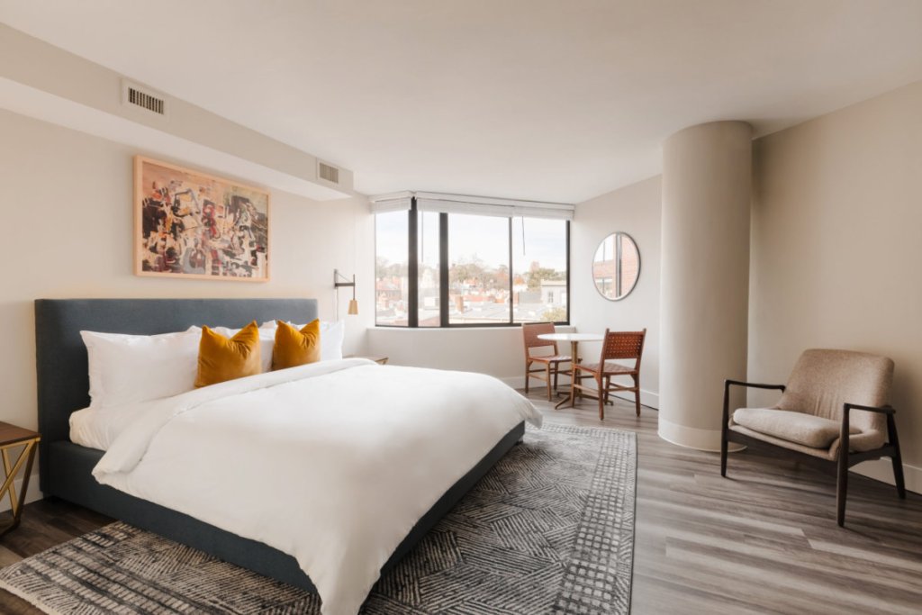 a guest room with a lot of space and light