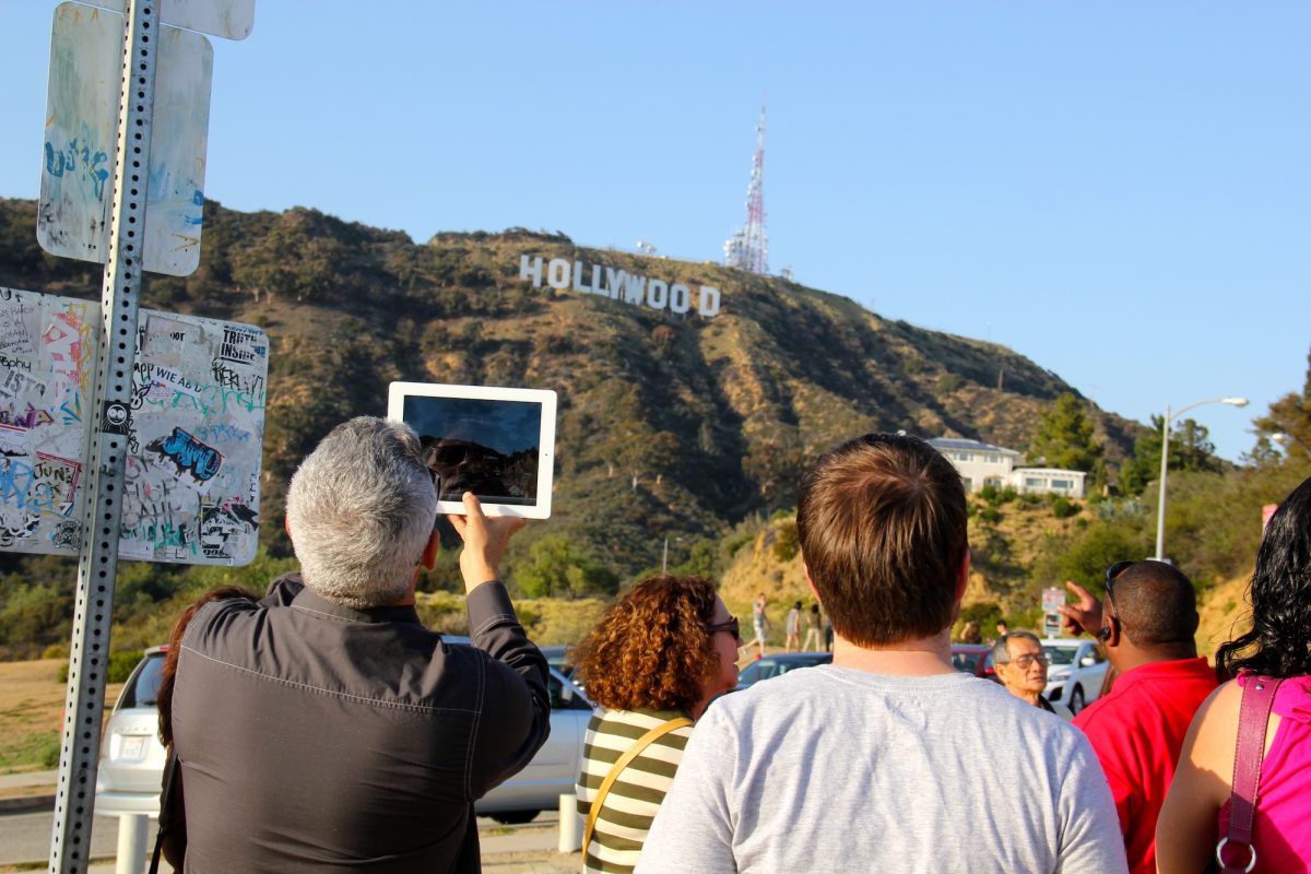 Tourists in California looking at the Hollywood sign.
