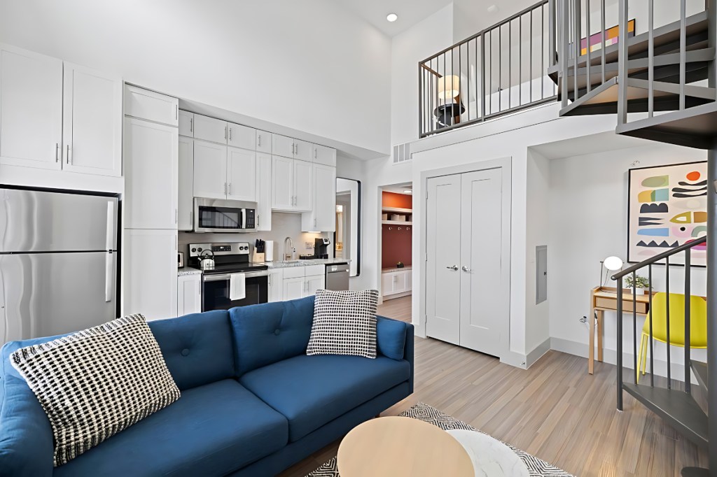 Image of the inside of a nicely furnished apartment that is offered for stays through Hilton and run by a third party called Placemakr.