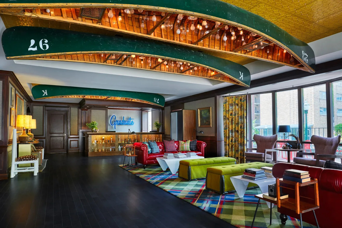 image of a hotel lobby at the Graduate by Hilton in Madison Wisconsin, with upside down rowboats on the ceiling.