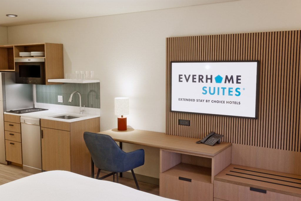 Image of a guest room and a brand new prototype for an extended stay property from Choice Hotels. Some modern Scandinavian style furnishings.