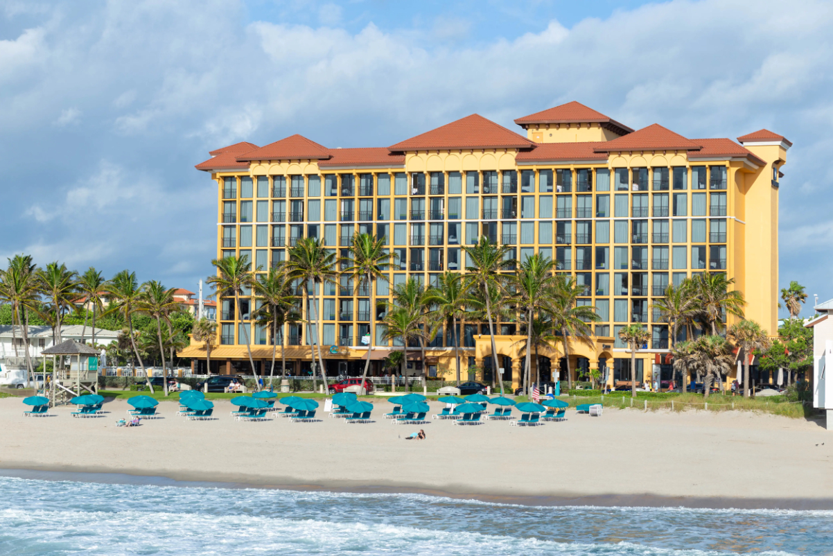 Image of a Florida resort from next year with chairs on the beach on a sunny day.