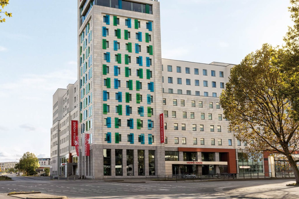 Exterior of a mid-market hotel in Berlin with the sign "Vienna House" outside.