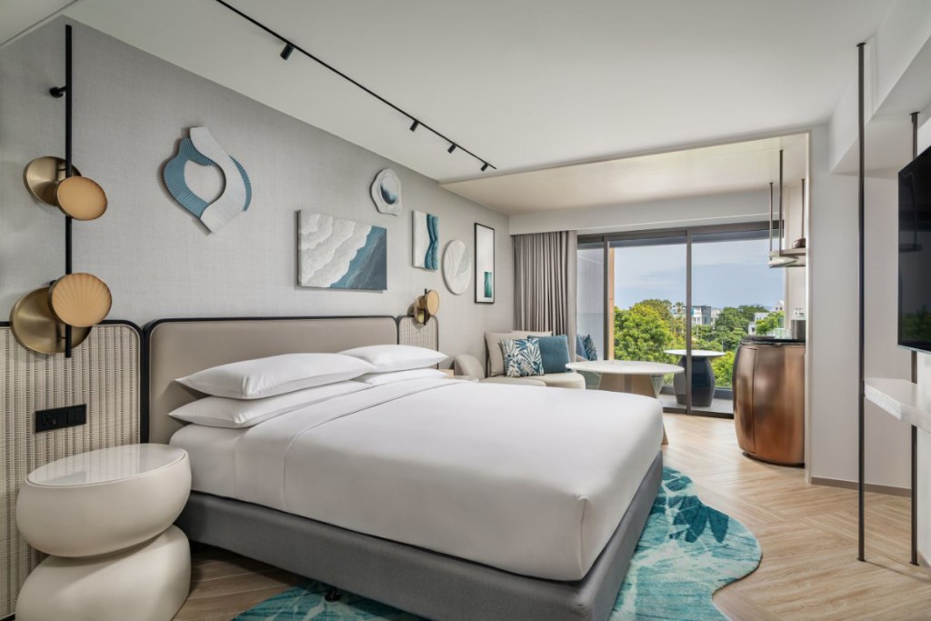 View of a family guest room at a Marriott resort in Thailand with a view through the window of a pretty resort on a sunny day