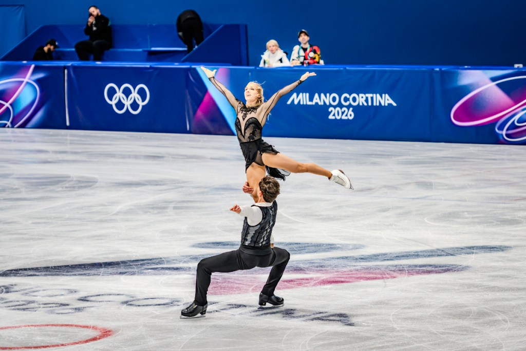 An image of figure skaters in a dramatic pose on ice at the Winter Olympics 2026 in Milan Cortina.